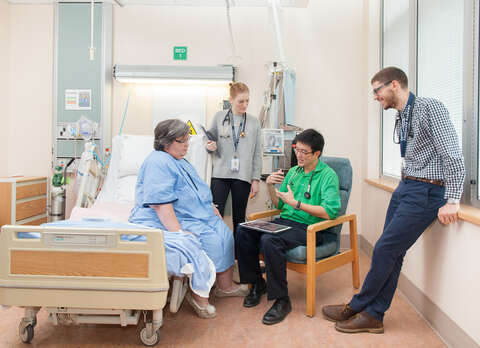 Medical students talking with a patient