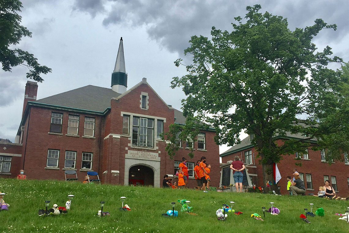 Tributes are brought to the Kamloops Indian Residential School monument area on May 31. U of T lowered its flags to half-mast this week in memory of the 215 children whose remains were found near the site (photo by Nicholas Rausch/AFP via Getty Images)